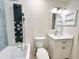 Stunning bathroom with a combination shower and bathtub featuring modern fixtures, tile and white vanity at 6308 Grove Blvd, Punta Gorda, FL 33982