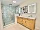 Beautiful bathroom featuring a double vanity, marble countertop and luxurious marble and glass shower at 6308 Grove Blvd, Punta Gorda, FL 33982