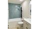 Gorgeous bathroom with a combination shower and bathtub featuring modern fixtures, mosaic tile and white vanity at 6308 Grove Blvd, Punta Gorda, FL 33982