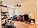 Bedroom or flex space with wood floors, window and ceiling fan, filled with personal items at 6308 Grove Blvd, Punta Gorda, FL 33982