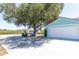 Exterior view of a spacious driveway and a large garage with ample parking and an adjacent grassy area at 6308 Grove Blvd, Punta Gorda, FL 33982