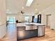 Modern kitchen island with an open view to the living room and pool area at 6308 Grove Blvd, Punta Gorda, FL 33982