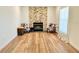 Comfortable living room with a stone fireplace, cowhide chairs, and natural light at 6308 Grove Blvd, Punta Gorda, FL 33982