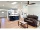Open-concept living room and kitchen featuring a center island, stainless steel appliances, and modern finishes at 6308 Grove Blvd, Punta Gorda, FL 33982