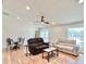 Living room with hardwood floors and view through door to pool at 6308 Grove Blvd, Punta Gorda, FL 33982