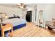 Bright main bedroom with a ceiling fan, wood floors, closet and view of ensuite bathroom at 6308 Grove Blvd, Punta Gorda, FL 33982