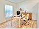 Bright home office with a large desk, comfortable chair, and natural wood furniture at 6308 Grove Blvd, Punta Gorda, FL 33982