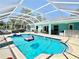 Inviting screened-in pool area with comfortable seating and a covered outdoor dining space at 6308 Grove Blvd, Punta Gorda, FL 33982
