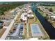 Aerial shot of the condo complex next to a canal featuring a tennis court and shuffleboard at 72 Boundary Blvd # 226, Rotonda West, FL 33947