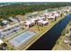 Beautiful aerial view of condos alongside the canal with tennis courts, shuffleboard and parking at 72 Boundary Blvd # 226, Rotonda West, FL 33947