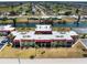 Community aerial view of a condominium complex with a central courtyard, canal access, and nearby golf courses at 72 Boundary Blvd # 226, Rotonda West, FL 33947