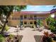 Inviting courtyard with patio furniture, lush landscaping, and vibrant foliage at 72 Boundary Blvd # 226, Rotonda West, FL 33947