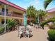 Community courtyard with tables, seating, and landscaping; perfect for relaxing outdoors at 72 Boundary Blvd # 226, Rotonda West, FL 33947