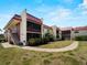 Well-maintained condo complex with colorful plants along the building exterior at 72 Boundary Blvd # 226, Rotonda West, FL 33947