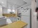 Compact kitchen with white cabinets and appliances, offering efficient use of space at 72 Boundary Blvd # 226, Rotonda West, FL 33947
