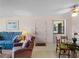 Living and dining area features a large window, ceiling fan, and a comfortable seating arrangement at 72 Boundary Blvd # 226, Rotonda West, FL 33947