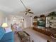 Open-concept living and dining area with a ceiling fan, and sliding glass door to a lanai at 72 Boundary Blvd # 226, Rotonda West, FL 33947