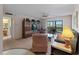 Living room features neutral walls, ceiling fan, and large sliding glass doors to a screened lanai at 72 Boundary Blvd # 226, Rotonda West, FL 33947