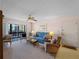 Comfortable living room and dining area with large sliding glass doors and a ceiling fan at 72 Boundary Blvd # 226, Rotonda West, FL 33947