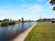 Scenic waterfront view along a canal with lush green grass at 72 Boundary Blvd # 226, Rotonda West, FL 33947