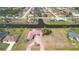Expansive aerial view of the home, showcasing a red tiled roof, large lot, and access to a canal at 730 Boundary Blvd, Rotonda West, FL 33947