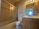Bathroom with a tub-shower combo and a vanity with wood cabinets and double sinks at 730 Boundary Blvd, Rotonda West, FL 33947