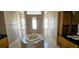 Luxurious bathroom with a jacuzzi tub, separate shower, and tile accents at 730 Boundary Blvd, Rotonda West, FL 33947