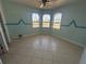 Bedroom with light-blue walls, tile floor, ceiling fan and three arched windows providing natural light at 730 Boundary Blvd, Rotonda West, FL 33947