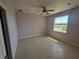 Bright bedroom with tile flooring and a large window offering serene pond views at 730 Boundary Blvd, Rotonda West, FL 33947
