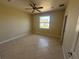 Bedroom featuring tile flooring, a standard closet, and a large window, ideal for personalization at 730 Boundary Blvd, Rotonda West, FL 33947