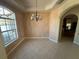 Cozy dining room with tile flooring, arched doorway, and a decorative chandelier at 730 Boundary Blvd, Rotonda West, FL 33947