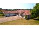 Aerial view of a single Gathering home with a tile roof, three car garage and manicured lawn at 730 Boundary Blvd, Rotonda West, FL 33947