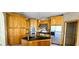 Kitchen featuring a black countertop island, stainless steel appliances and custom wood cabinets at 730 Boundary Blvd, Rotonda West, FL 33947