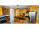 Spacious kitchen featuring custom wood cabinets, black countertops and stainless steel appliances at 730 Boundary Blvd, Rotonda West, FL 33947