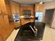 Kitchen featuring stainless steel appliances, custom wood cabinets and granite countertops at 730 Boundary Blvd, Rotonda West, FL 33947