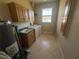 Functional laundry room featuring a washer, dryer, utility sink, and ample cabinet storage at 730 Boundary Blvd, Rotonda West, FL 33947