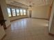 Bright living room with tile floors, tray ceiling, and large bay window overlooking the water at 730 Boundary Blvd, Rotonda West, FL 33947