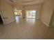 Open living room with tile flooring and views of the enclosed patio at 730 Boundary Blvd, Rotonda West, FL 33947