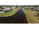 Scenic waterfront view of community canal, showcasing lush landscaping and neighborhood homes at 730 Boundary Blvd, Rotonda West, FL 33947
