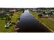 Picturesque waterfront view of a serene community canal lined with well-manicured lawns and mature trees at 730 Boundary Blvd, Rotonda West, FL 33947