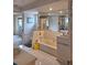 Bright bathroom with a sunken tub, tiled walls, vanity and large mirrors at 2575 Brazilia Ct, Punta Gorda, FL 33950