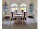 Formal dining room with large oval table, six chairs, and decorative glass shelving at 2575 Brazilia Ct, Punta Gorda, FL 33950