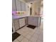Modern kitchen with grey cabinetry, stainless dishwasher, white appliances, a decorative plate rack and an island sink at 2575 Brazilia Ct, Punta Gorda, FL 33950