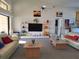 Bright living room with vaulted ceiling, ceiling fan, two sofas, entertainment center and access to adjacent rooms at 2575 Brazilia Ct, Punta Gorda, FL 33950
