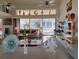 Bright living room featuring large windows with canal views, sofas and ceiling fans at 2575 Brazilia Ct, Punta Gorda, FL 33950