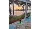 Relaxing outdoor seating area with a waterfront view and palm trees at 2575 Brazilia Ct, Punta Gorda, FL 33950