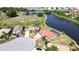 An aerial view shows a beautiful home backing onto a pond and golf course at 10203 Windsong Rd, Punta Gorda, FL 33955