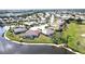 Beautiful aerial view of a home nestled on the water overlooking lush golf course at 10203 Windsong Rd, Punta Gorda, FL 33955