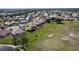 Aerial view of the home overlooking a scenic golf course with a pond and lush landscaping at 10203 Windsong Rd, Punta Gorda, FL 33955