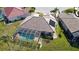 Aerial view of a home showcasing a screened-in pool and a well-maintained lawn at 10203 Windsong Rd, Punta Gorda, FL 33955